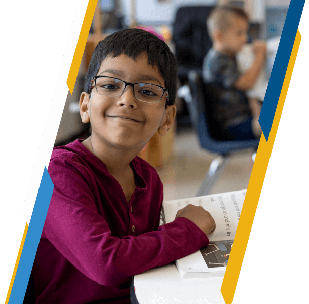 Elementary-school-aged student with a book