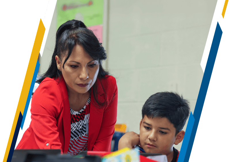 Elementary school educator helping a student on the computer