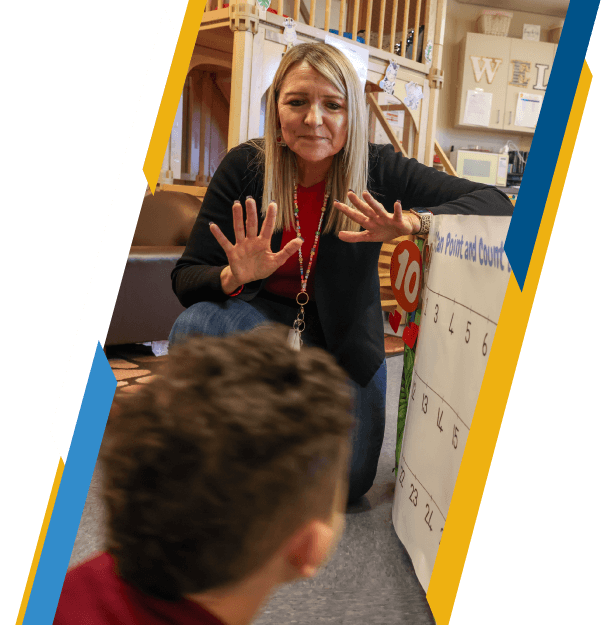 Elementary school teacher working with a student with counting